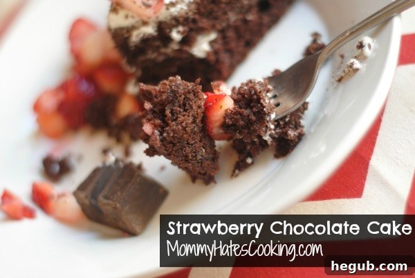 Luscious Strawberry Chocolate Dream 6 A large, inviting strawberry chocolate cake on a platter, ready to be sliced, garnished with strawberries and chocolate shavings
