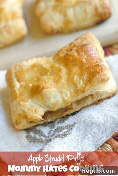 Freshly baked golden apple strudel puffs, glistening and ready to be enjoyed.