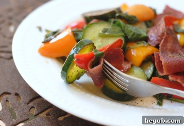 Serving of Bacon & Veggie Salad topped with fresh ground black pepper