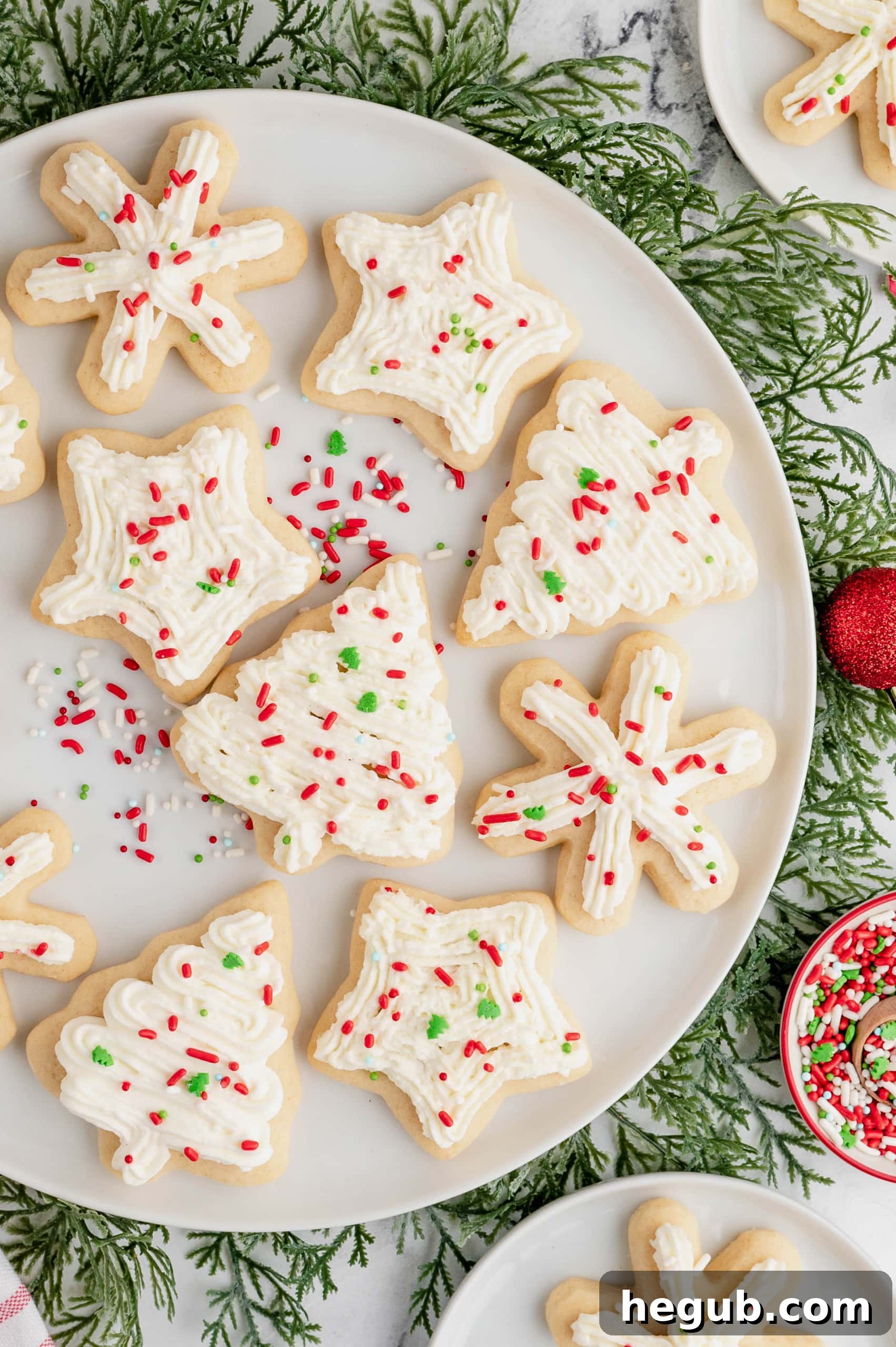 Delightful Old Fashioned Christmas Cookies topped with whipped cream and festive sprinkles