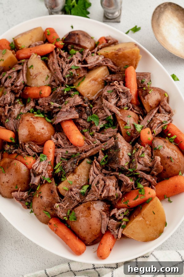 Tender 4-Ingredient Slow Cooker Roast Beef 7 Cooked 4-ingredient slow cooker roast beef, shredded and ready to serve