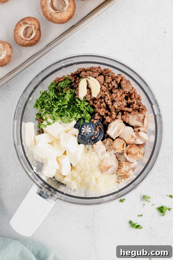 An array of fresh, raw baby portobello mushrooms alongside the core stuffing ingredients: ground sausage, cream cheese, and fresh parsley, neatly arranged on a wooden board.