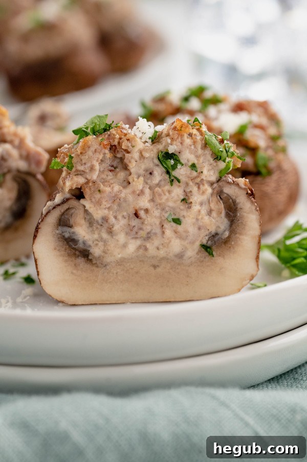 A elegantly arranged serving board showcasing a generous portion of Stuffed Baby Portobello Mushrooms, ready for guests to enjoy at a party or social gathering.