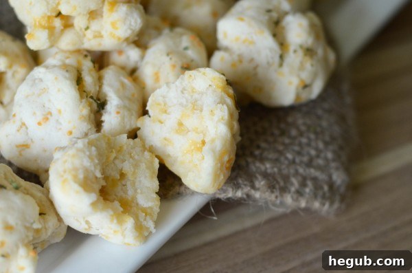 Gluten-free cheddar bay biscuits neatly stacked in an airtight container for storage