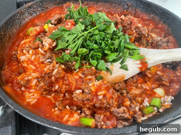 Close-up of stuffed peppers filling being prepared in a skillet