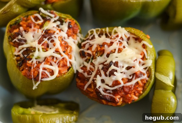 A cutting board with halved bell peppers, ready for stuffing