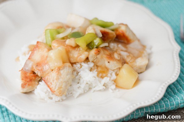 Close-up of freshly cooked Sweet and Sour Chicken with a glistening sauce and colorful bell peppers.