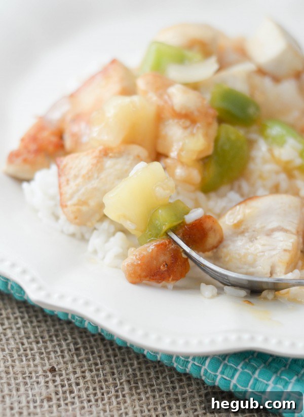 Sweet and Sour Chicken meal with a generous amount of sauce and rice, ready to be served.