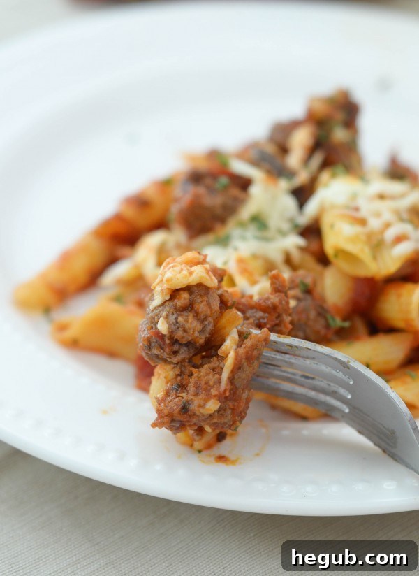 Bowl of Homestyle Cheesy Penne garnished with fresh basil