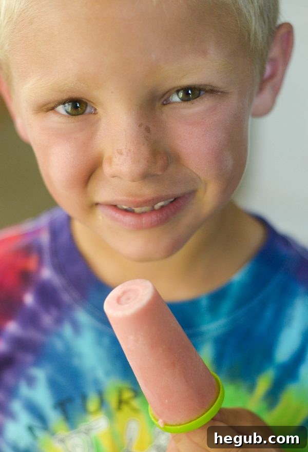 A hand holding a Watermelon Yogurt Pop