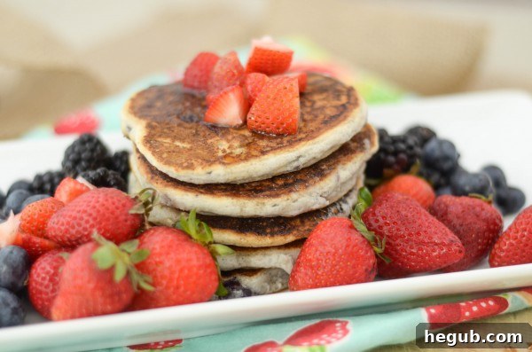 Close-up of fluffy Gluten-Free Pancakes topped with fresh berries
