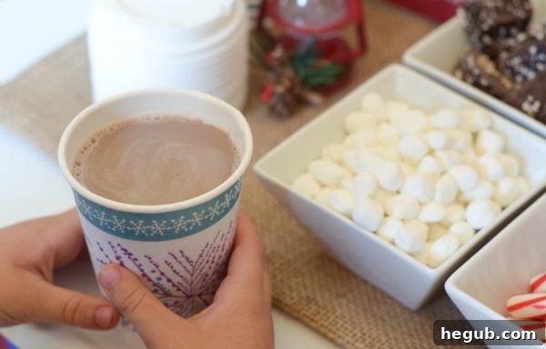Close-up of a cup being filled with hot chocolate, surrounded by enticing toppings.