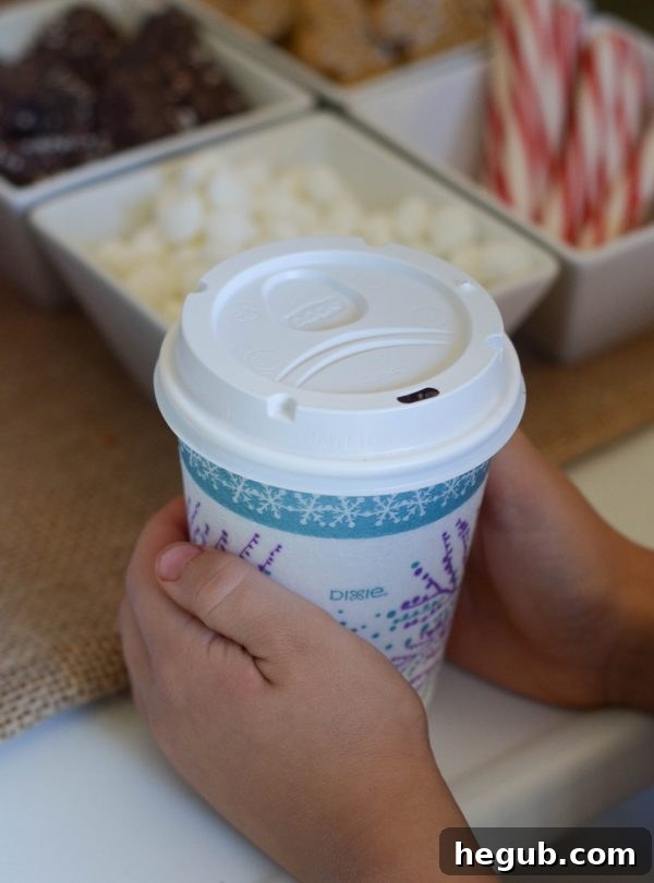 Children and adults enjoying their customized hot chocolate drinks with various toppings.