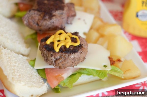 Hand holding a delicious Hawaiian Beef Slider with French's condiments
