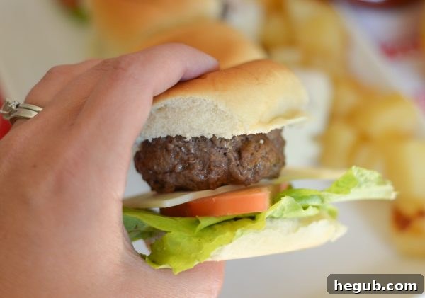 Multiple Hawaiian Beef Sliders on a platter, garnished with fresh toppings