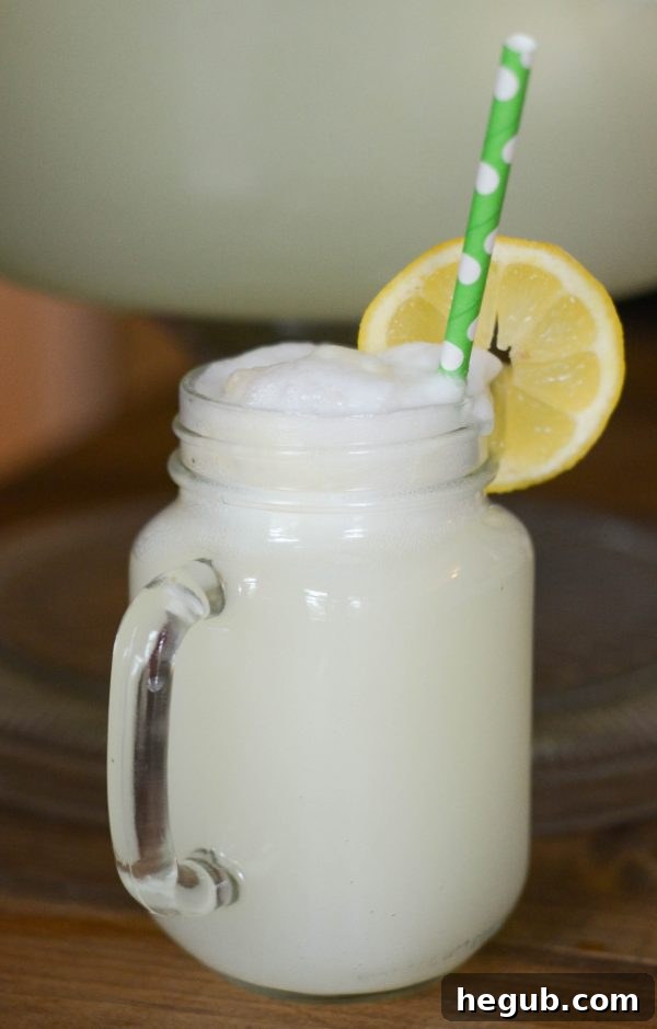 Golden Citrus Cooler 2 Lemonade Punch in a glass with lemon slices