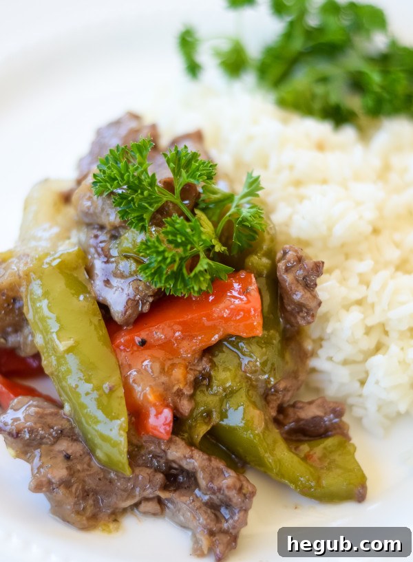 Creamy Beef and Peppers served over rice in a bowl