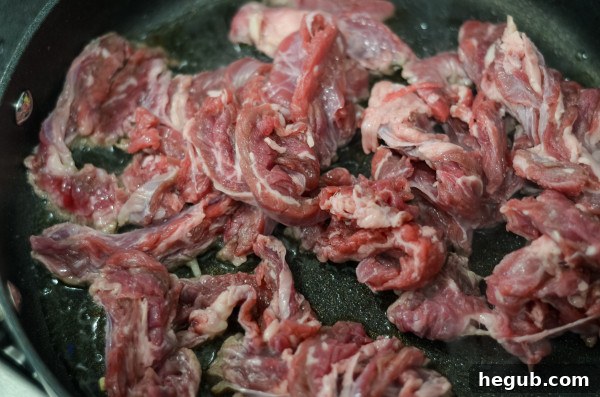 Thinly sliced beef steak cuts on a cutting board