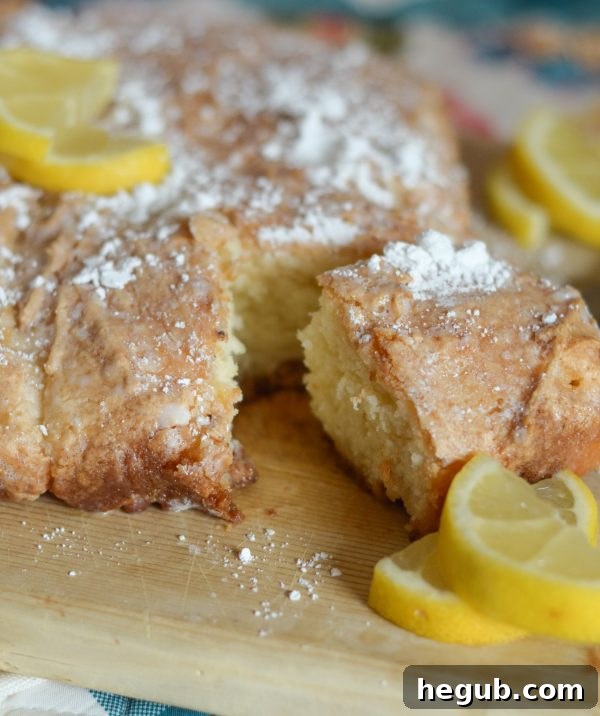 Zesty Vanilla Lemon Loaf 6 A hand holding a slice of Vanilla Lemon Bread, with a blurred background of a cozy outdoor setting