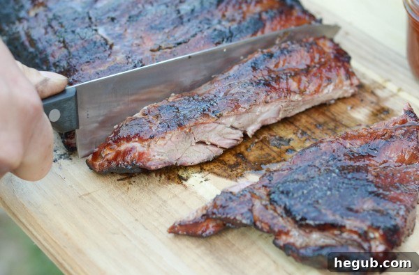 Maple Sugar Ribs, glistening with a sweet glaze and perfectly tender from the grill. This image is a mouthwatering example of classic BBQ ribs for summer cookouts.