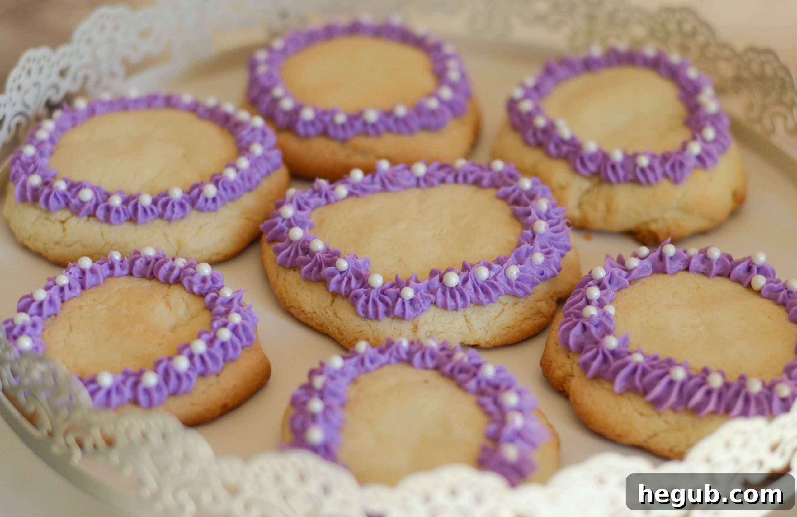 Close-up of a beautifully decorated Sofia the First cookie with purple icing and sugar pearls.