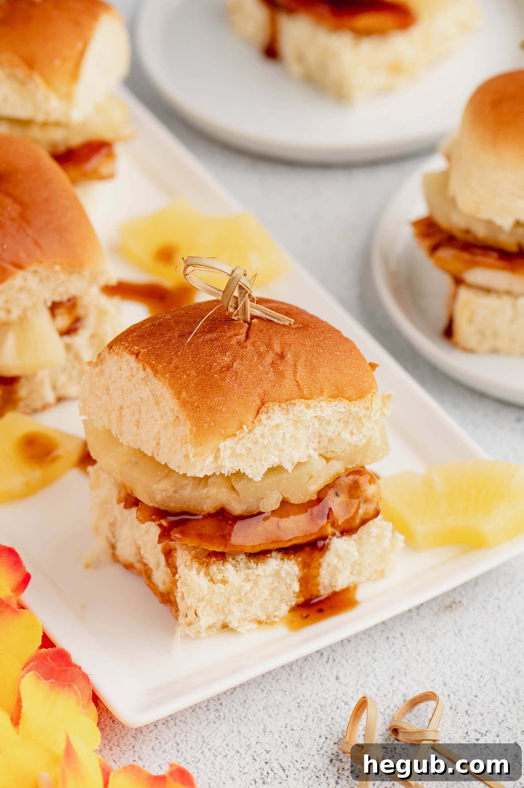 A plate of two Hawaiian Chicken Sliders with a side of coleslaw.