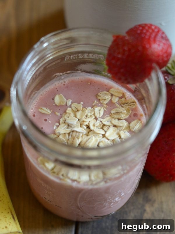Two glasses of homemade Strawberry Banana Oat Smoothie, prepared for a quick and nutritious back-to-school breakfast.