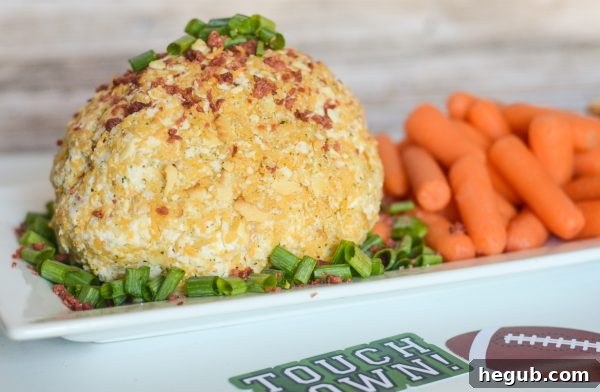 Bacon Cheddar Cheese Ball with crackers and veggies, a delicious and easy party snack.