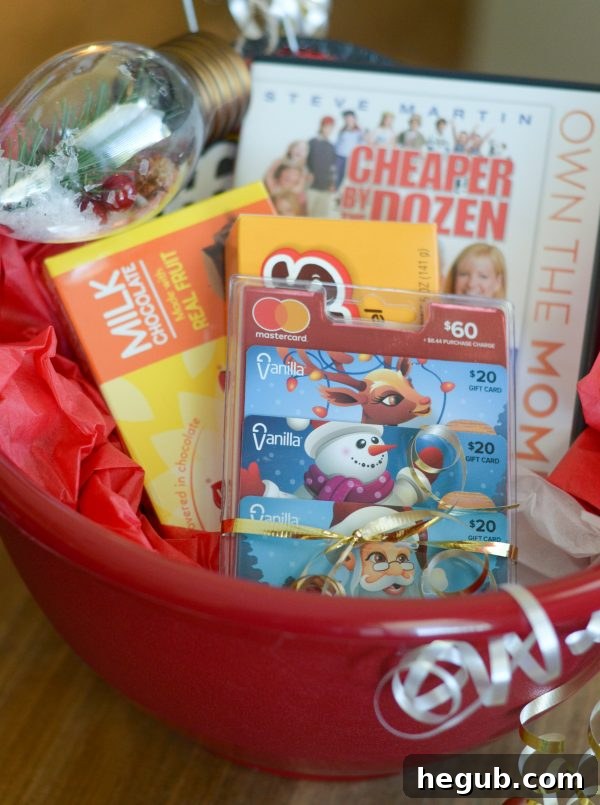 Beautifully arranged Movie Night Gift Basket featuring a large popcorn bowl, various candies, a popular movie, and versatile gift cards, perfect for spreading holiday cheer.
