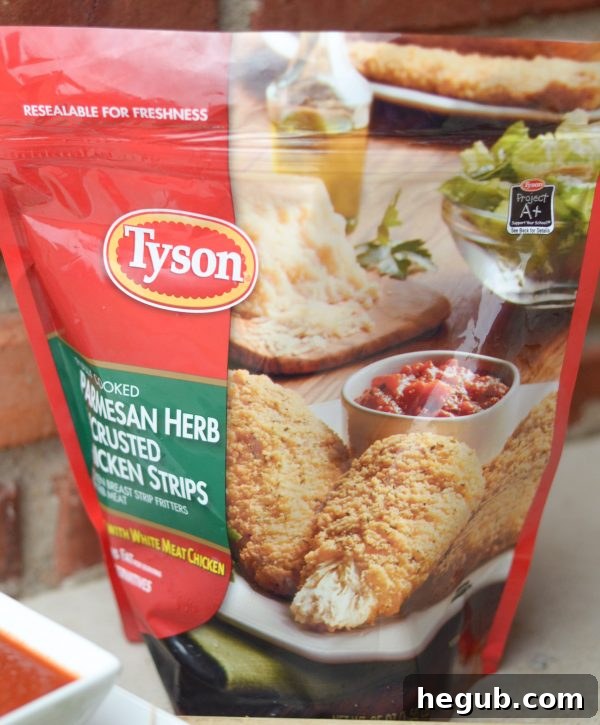 Easy Party Food: Parmesan Herb Bites, featuring Tyson Chicken, ideal for a festive gathering, served alongside marinara sauce.