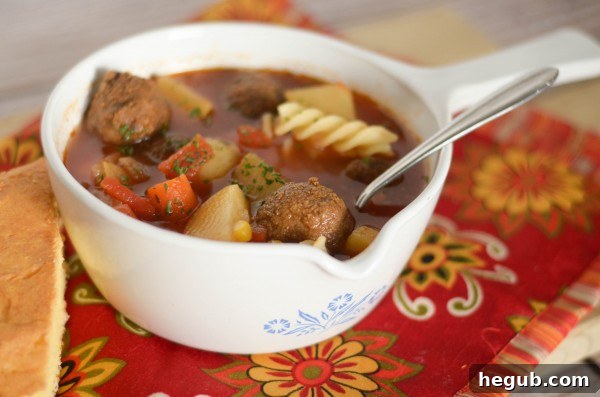 A hearty bowl of vegetable soup, perfect for cold winter days, highlighting the comfort of slow cooker meals.