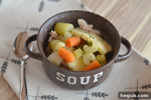 A steaming bowl of Slow Cooker Chicken Noodle Soup, a classic cold weather remedy.