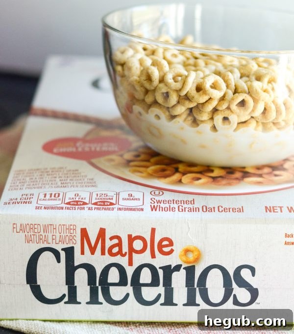 Happy family enjoying breakfast together with a bowl of Maple Cheerios on the table.