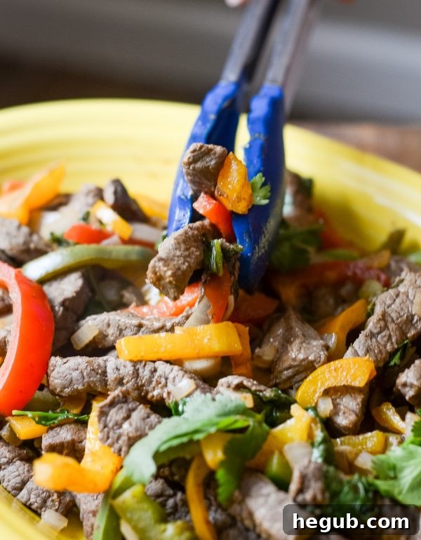Skillet with marinated beef fajita strips