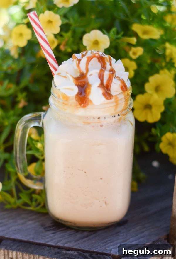 Various ingredients laid out for Frozen Caramel Coffee: coffee, milk, caramel sauce, vanilla extract, and a glass of ice.