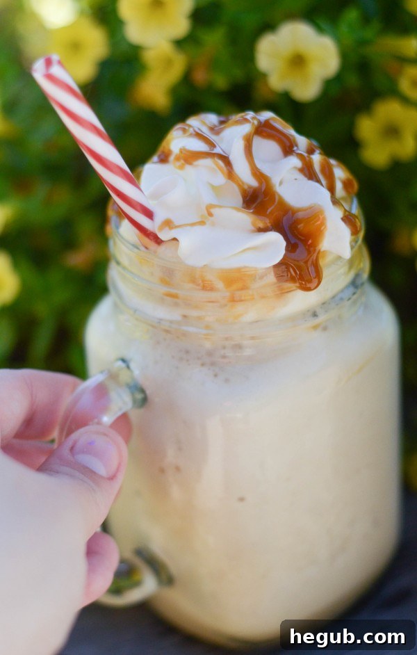 A bottle of rich caramel sauce next to a spoonful of the gooey caramel, emphasizing the ideal choice for frozen coffee.
