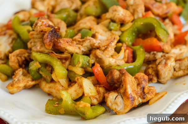 A bowl of vibrant homemade fajita seasoning mix, ready to flavor chicken and vegetables