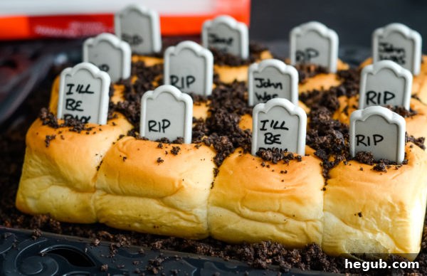 Chocolate cream cookies being crushed to make edible 'dirt' for the graveyard rolls