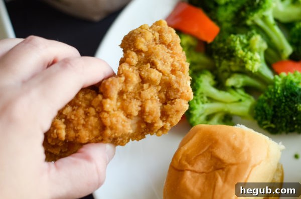 Air fryer basket with frozen Tyson chicken strips