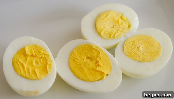 Close-up view of perfectly peeled hard-boiled eggs, ready to be sliced and prepared for deviled eggs.