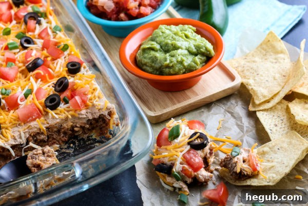 Close-up shot of the finished Layered Taco Dip with tortilla chips