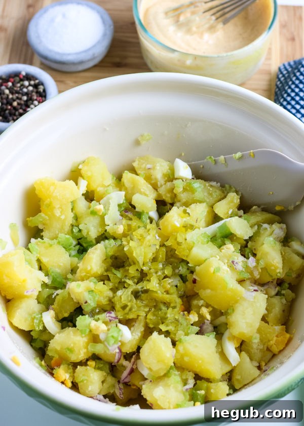 This image is mixing together potato salad.