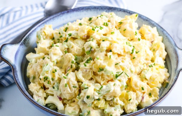 This image shows a bowl of potato salad ready to serve.