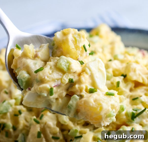 Showing a spoonful of gluten free potato salad.