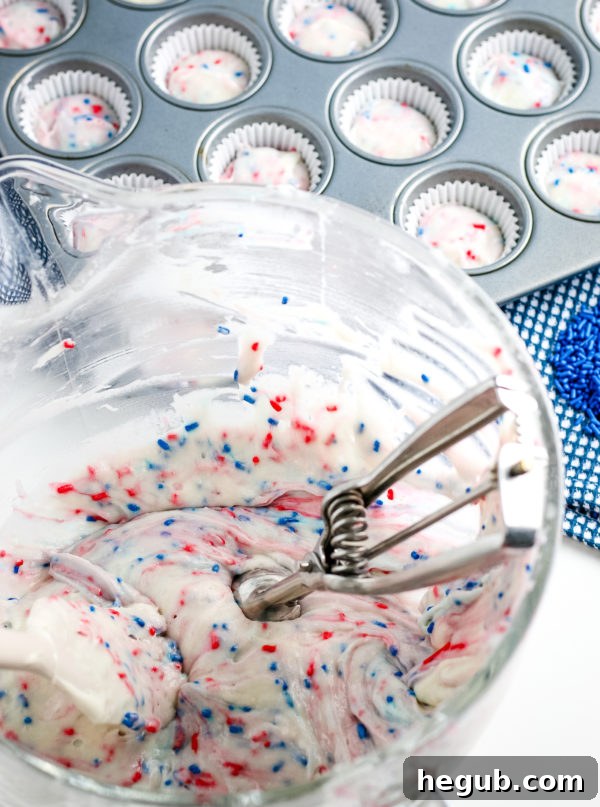 Close-up of Gluten-Free Mini Patriotic Cupcakes with red and blue sprinkles folded into the batter.