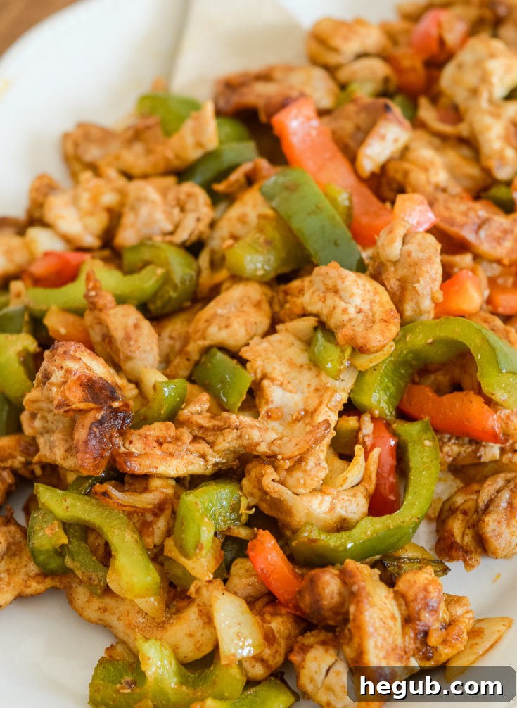 Sizzling Air Fryer Chicken Fajitas with bell peppers and onions.