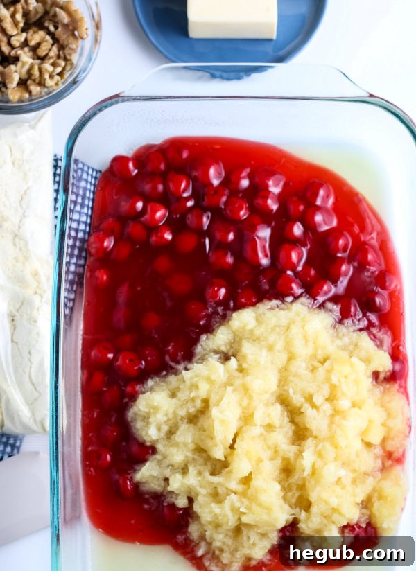Ingredients for a gluten-free cherry dump cake: cherry pie filling, pineapple, cake mix, and butter