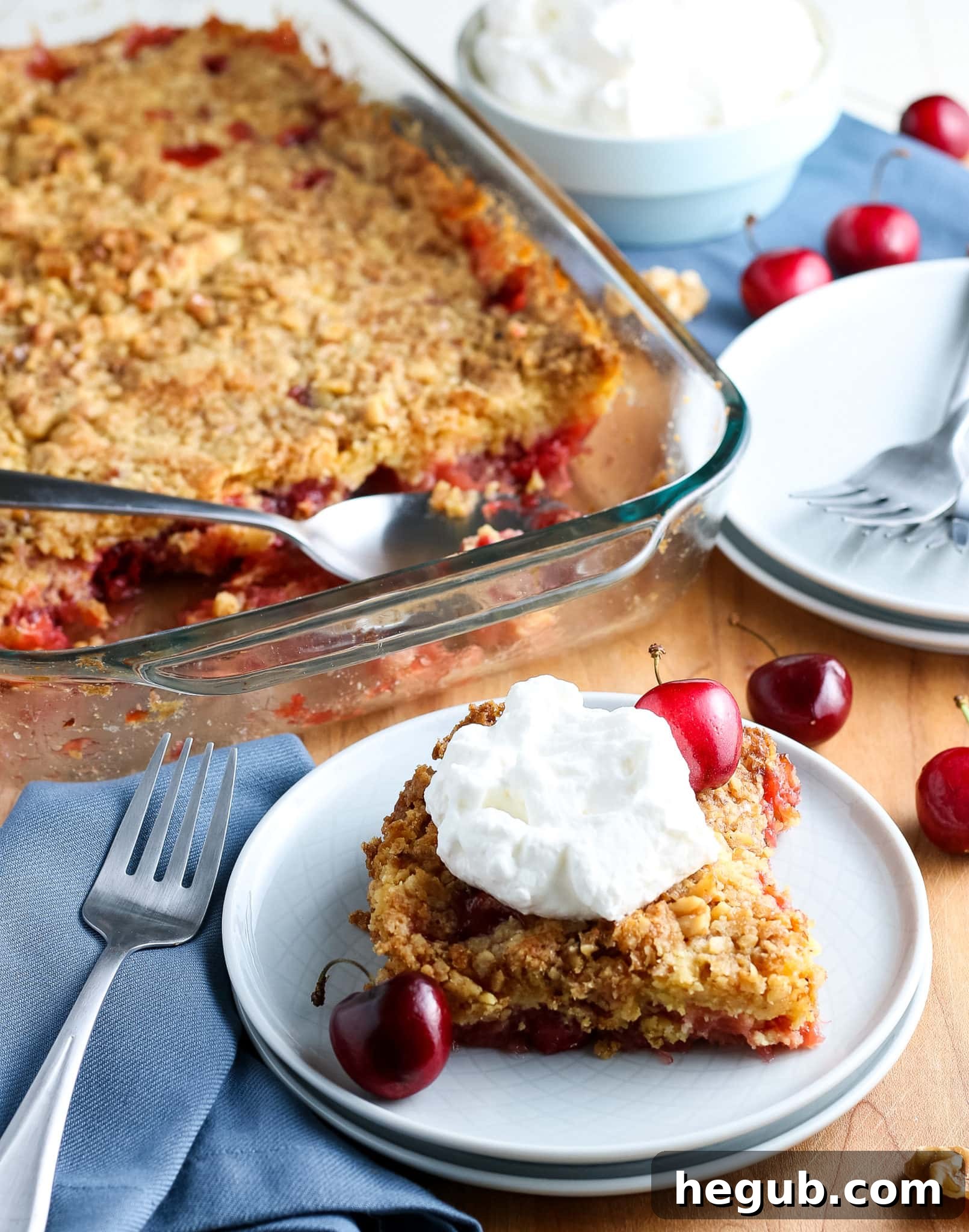 Serving of Classic Cherry Dump Cake topped with vanilla ice cream