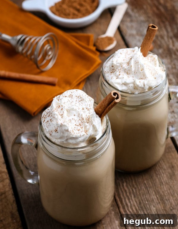 Homemade Pumpkin Spice Latte in a mug, garnished with whipped cream and a sprinkle of cinnamon.