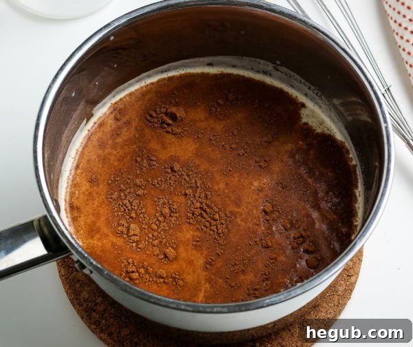 A close-up of a pumpkin spice latte with a rustic background, highlighting its warm color and creamy texture.